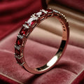 Gold ring with red crystal inlays